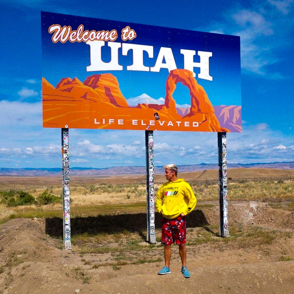 Standing beneath the Welcome to Utah Sign, Life Elevated. 